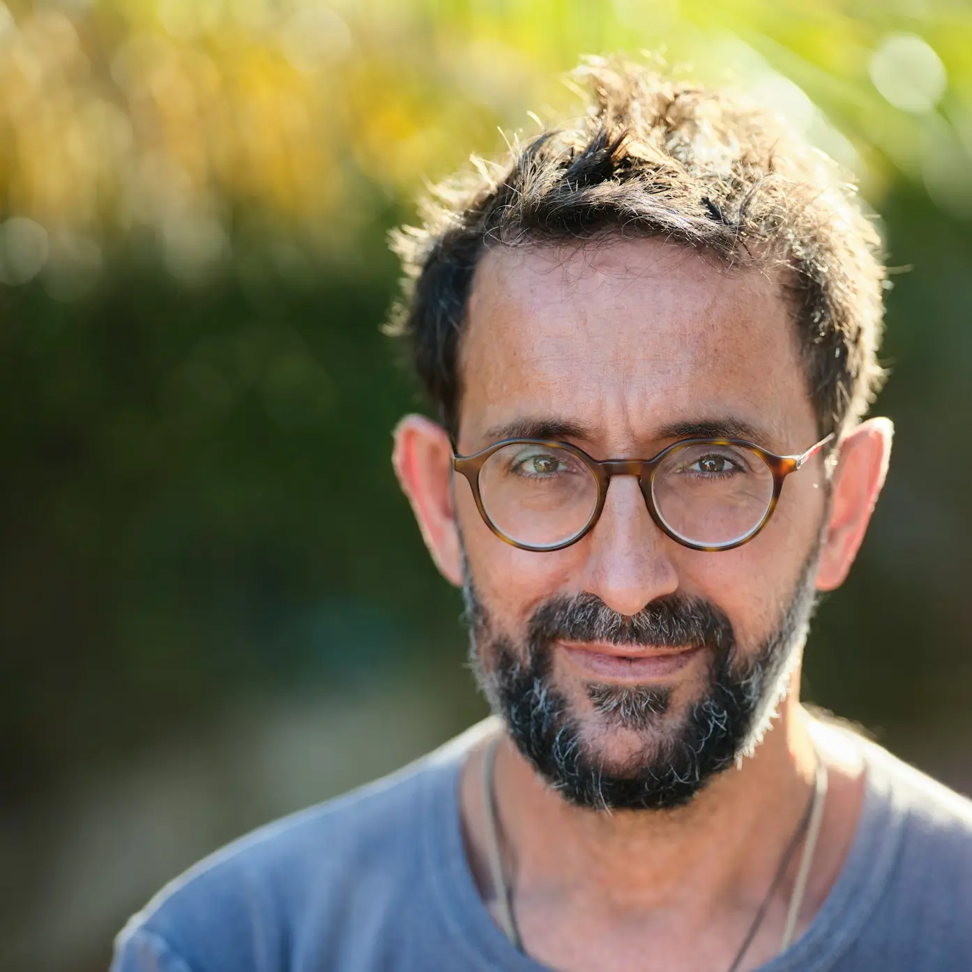 man in blue crew neck shirt wearing black framed eyeglasses